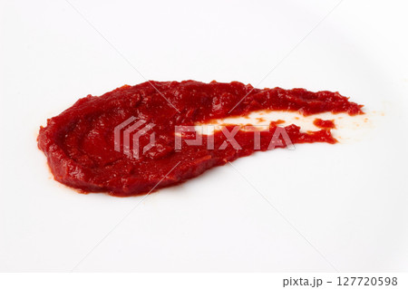red blob of tomato ketchup paste smeared on white table. isolated on white background red blob of tomato ketchup paste smeared on white table. isolated on white background 127720598