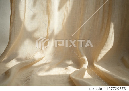 soft beige linen fabric backdrop with natural light and subtle shadows, creating minimalist and serene atmosphere 127720878