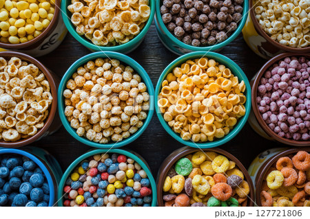 Colorful cereal bowls filled with various breakfast cereals arranged neatly Colorful cereal bowls filled with various breakfast cereals arranged neatly 127721806