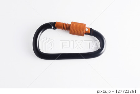 Black and orange aluminum screw lock carabiner, commonly used for camping, fishing, hiking and keyring. 127722261