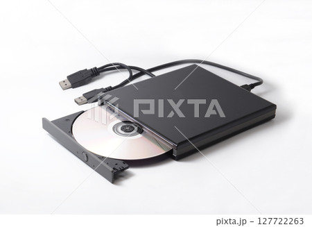 External DVD drive with a compact disc inside, used for DVD player or DVD burner, operated from a laptop or desktop using USB connector cable. Isolated on white. 127722263