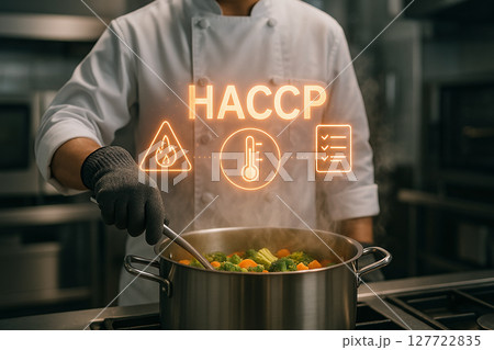 Chef in industrial kitchen cooking vegetables in boiling water while applying HACCP standards for thermal processing and food safety compliance control 127722835