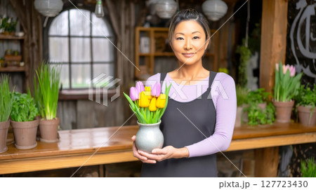 Young smiling asian woman is holding beautiful 127723430