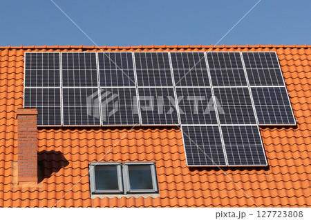 Solar panels on tiled house roof 127723808