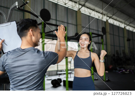Personal Trainer and Client Engaging in Fitness Session Personal Trainer and Client Engaging in Fitness Session 127726823
