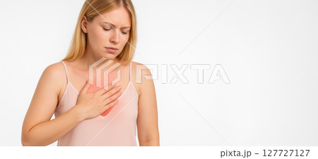 Caucasian woman experiencing chest pain while holding her hand on her chest in discomfort. concept of health concern, physical distress, healthcare awareness, Wide banner, copy space, white background 127727127