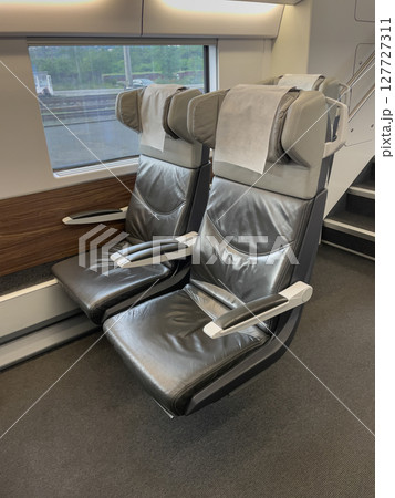 Comfortable seats inviting passengers aboard modern high-speed train Comfortable seats inviting passengers aboard modern high-speed train 127727311