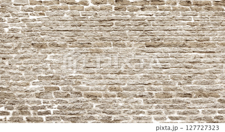 Old beige brick wall forming a textured background Old beige brick wall forming a textured background 127727323
