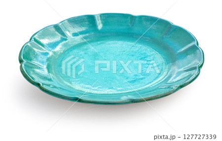 Empty teal ceramic plate with scalloped edge on white background Empty teal ceramic plate with scalloped edge on white background 127727339