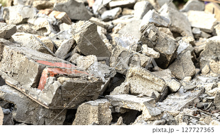 Pile of concrete and brick rubble creating textured debris 127727365