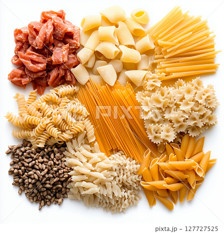 Varied pasta shapes and ingredients arranged on white backdrop 127727525