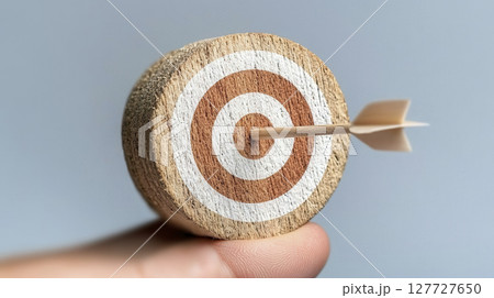 Small cork target with arrow, showcasing precision and focus 127727650