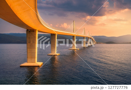 Modern Peljesac bridge and blue sea at colorful sunset in summer 127727776