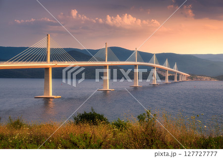 Modern Peljesac bridge and blue sea at colorful sunset in summer 127727777