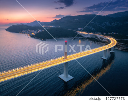 Aerial view of modern Peljesac bridge and blue sea at night 127727778