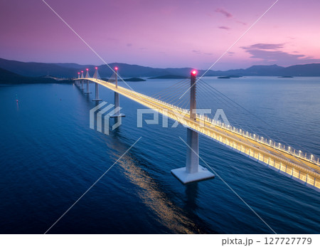 Aerial view of modern Peljesac bridge and blue sea at night 127727779