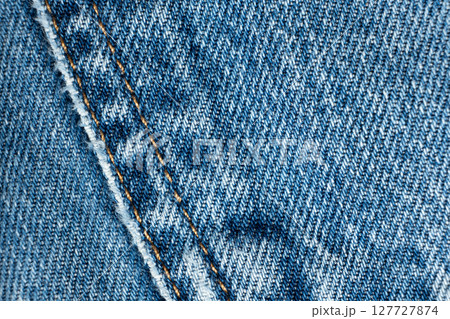Detailed View of Blue Jeans Fabric and Thread Stitching 127727874