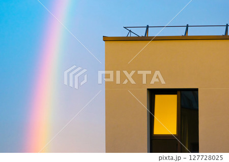 Rainbow in the sky and flat apartment window Rainbow in the sky and flat apartment window 127728025