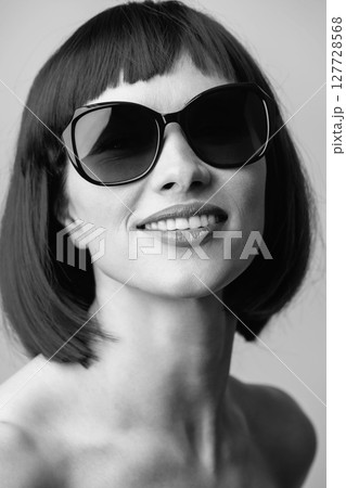 Close-up beautiful woman with wig and sunglasses studio portrait 127728568