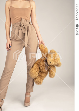 Woman holding fluffy bear toy in her hands Woman holding fluffy bear toy in her hands 127728647