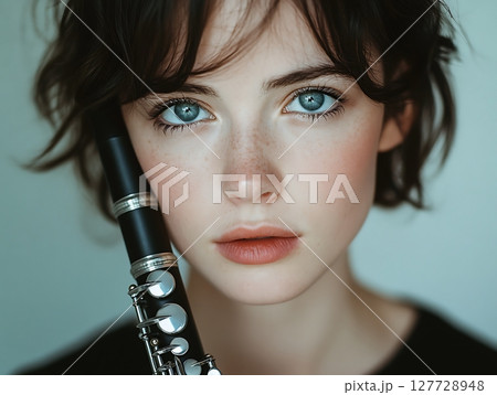 Portrait of a Woman Holding a Clarinet with Grace 127728948
