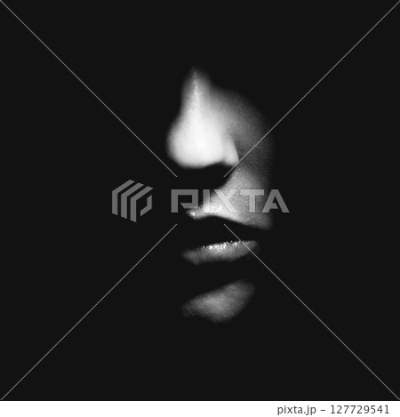Part of woman face in black shadow background Part of woman face in black shadow background 127729541
