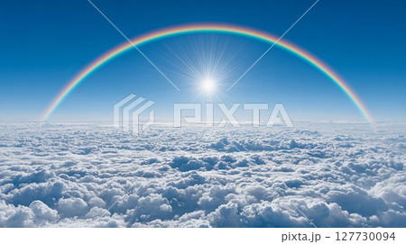 Colorful rainbow arches above fluffy clouds under a bright sun in a clear blue sky, showcasing nature s dazzling beauty and tranquility during daytime 127730094