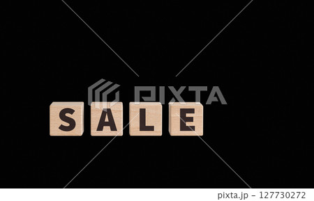 Wooden Blocks with SALE Text on black Background for Advertising Campaigns Wooden Blocks with SALE Text on black Background for Advertising Campaigns 127730272