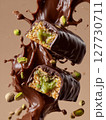 Dubai Chocolate Pistachio Bars with Kataifi Dough. Broken in half with rich, glossy melted chocolate coating and a golden crispy texture underneath, luxury food advertising style. AI Generative 127730711
