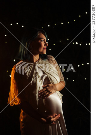 Beautiful pregnant woman in silky satin dress.Elegant maternity, wedding, bride  127730807