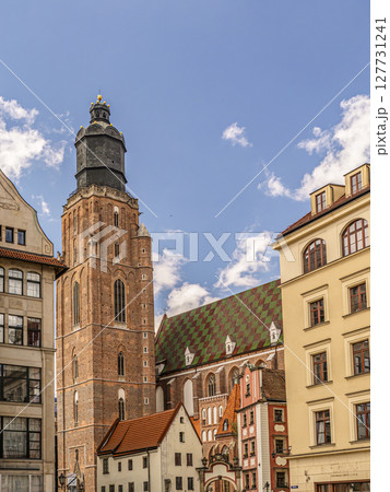 Historic St. Elisabeth Church Tower and Colorful Buildings Against a Bright Blue Sky Historic St. Elisabeth Church Tower and Colorful Buildings Against a Bright Blue Sky 127731241