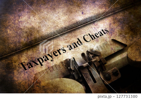 Taxpayers and cheats text on vintage typewriter Taxpayers and cheats text on vintage typewriter 127731380