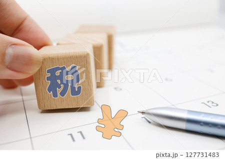 税金の納付期限や確定申告を意識させるカレンダーとブロックの構図 税金の納付期限や確定申告を意識させるカレンダーとブロックの構図 127731483