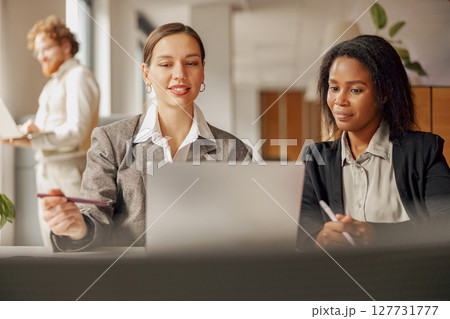 Engaging and Collaborative Business Meeting Taking Place in a Modern Office Environment 127731777