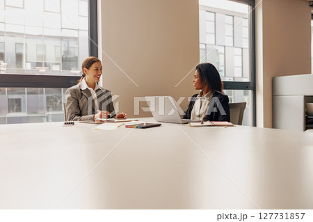 A Collaborative Business Meeting Between Two Professionals Taking Place in a Modern Office Space A Collaborative Business Meeting Between Two Professionals Taking Place in a Modern Office Space 127731857
