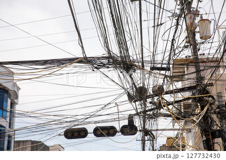 Chaotic overhead power lines and tangled cables for concepts of infrastructure problems, urban overload, or communication failure 127732430