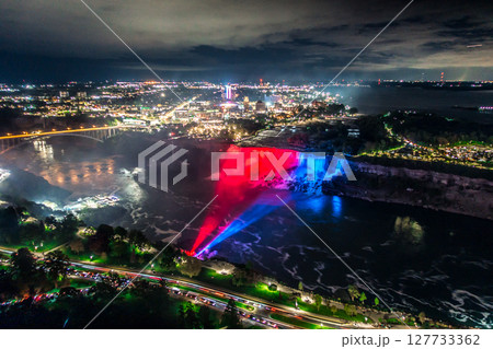 Niagara Falls frozen at night with colorful lights Niagara Falls frozen at night with colorful lights 127733362