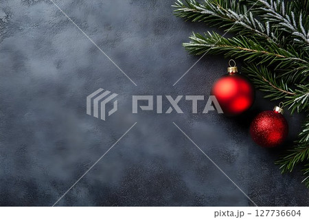 Red christmas baubles and fir branch on dark background 127736604