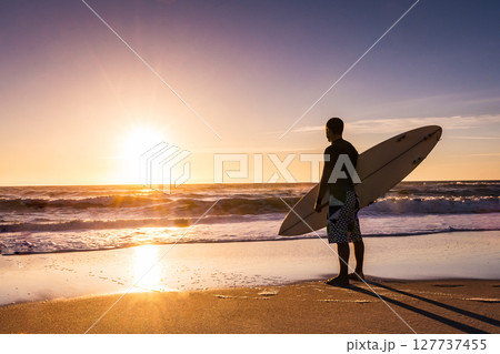 Surfer watching the waves 127737455