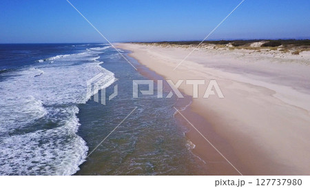 Low flying along sand beach shore 127737980
