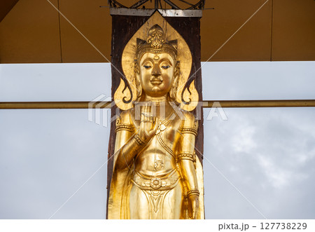 Standing Buddha made by wood carving style from Hopea odorata tree situated at Wat Pa Kluay temple in Chiang Rai province of Thailand. Standing Buddha made by wood carving style from Hopea odorata tree situated at Wat Pa Kluay temple in Chiang Rai province of Thailand. 127738229