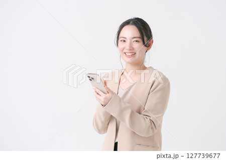 スマホを持つスーツの女性 127739677