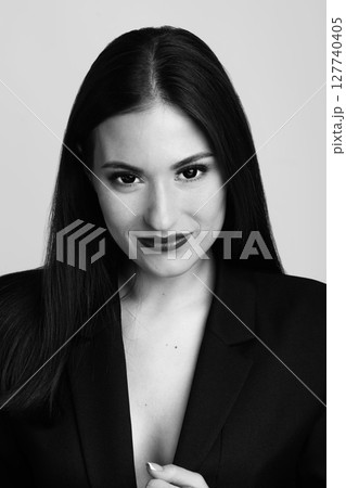 Beautiful woman with long dark hair and classic suit studio portrait 127740405