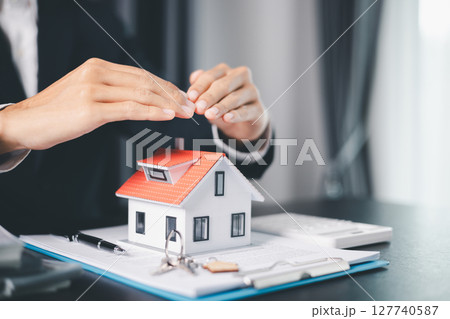 Concept business house finance protection office plan investment buy sell home ensuring idea financial security. residence agent hand protect purchase insurance and secure favorable loan deal. 127740587