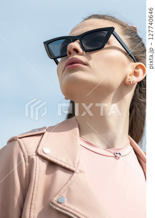 Beautiful woman with long dark hair and sunglasses outdoor close-up portrait 127740646
