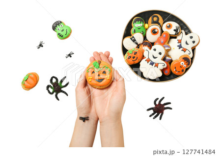 Hands hold a festive Halloween cookie, isolated on white, PNG 127741484
