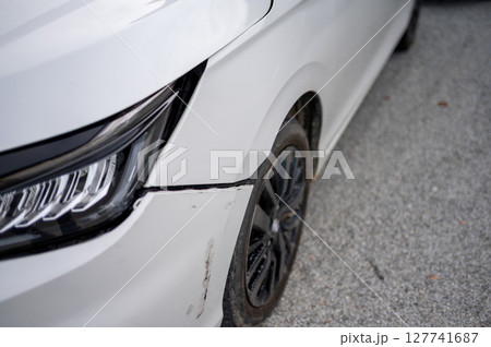 White car with front bumper misalignment and minor scratches White car with front bumper misalignment and minor scratches 127741687