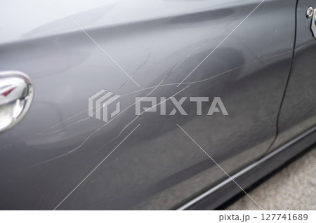 Grey car door with multiple long scratches Grey car door with multiple long scratches 127741689