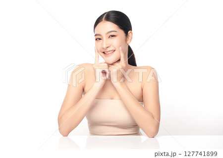 A beautiful young Asian woman with clean, fresh skin against a white background. Skincare, facial treatment, cosmetology, beauty, and spa. An elegant portrait of an Asian woman. A beautiful young Asian woman with clean, fresh skin against a white background. Skincare, facial treatment, cosmetology, beauty, and spa. An elegant portrait of an Asian woman. 127741899