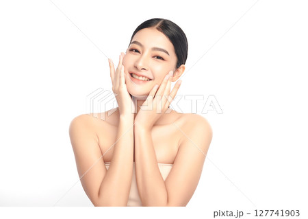 A beautiful young Asian woman with clean, fresh skin against a white background. Skincare, facial treatment, cosmetology, beauty, and spa. An elegant portrait of an Asian woman. A beautiful young Asian woman with clean, fresh skin against a white background. Skincare, facial treatment, cosmetology, beauty, and spa. An elegant portrait of an Asian woman. 127741903